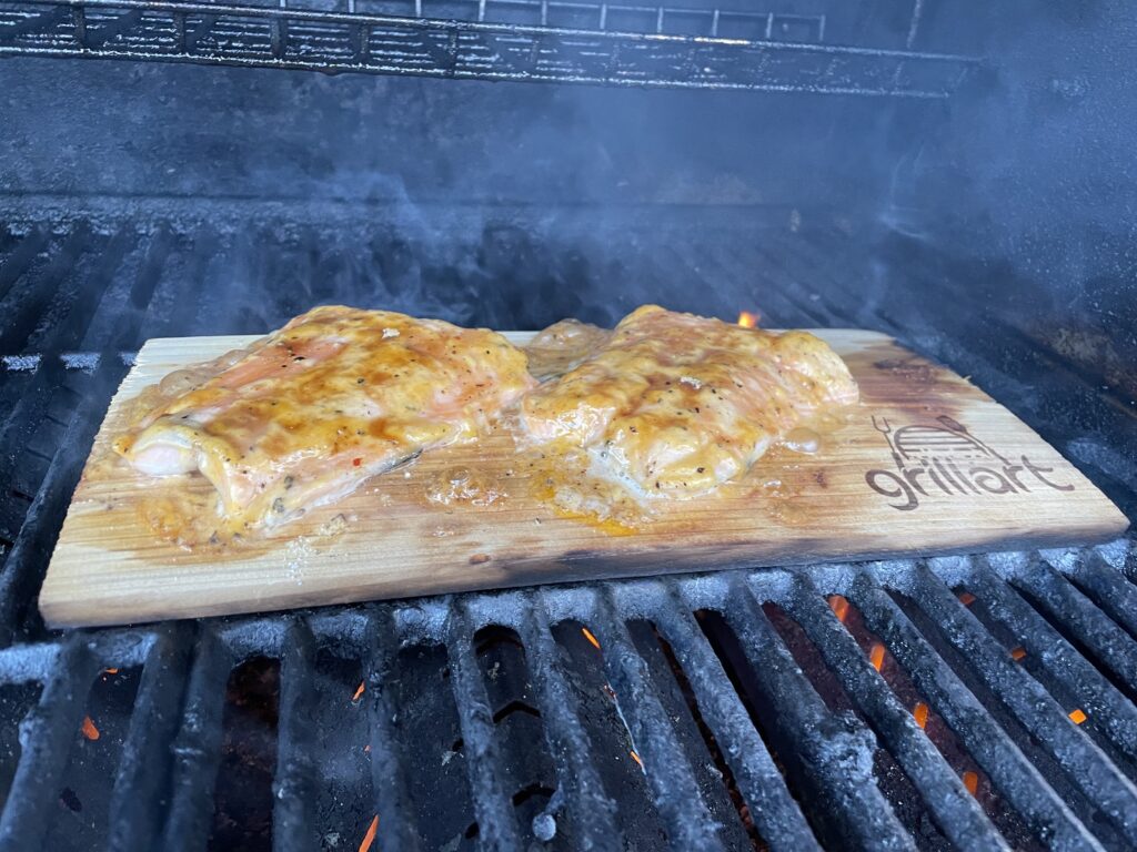 Trout grilling on cedar plank