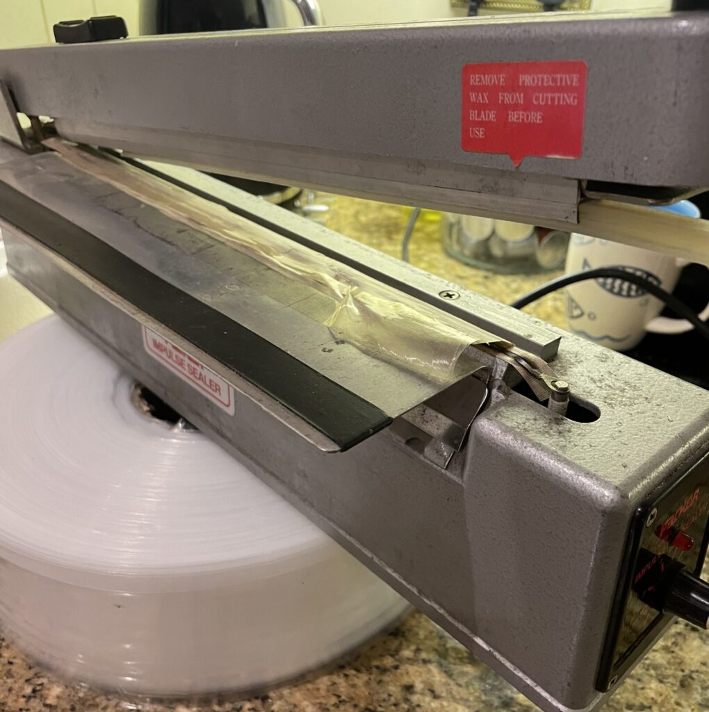 Plastic bag heat sealer